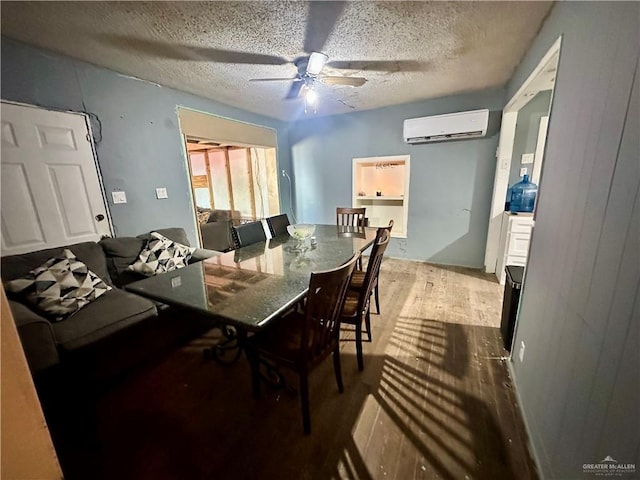 dining room featuring ceiling fan, a textured ceiling, wood finished floors, and a wall mounted AC