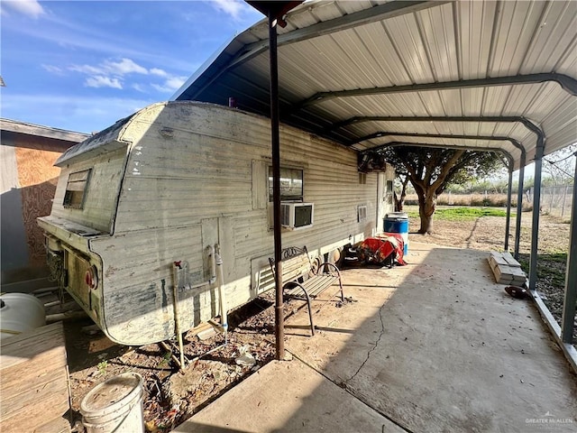 exterior space featuring cooling unit and a detached carport