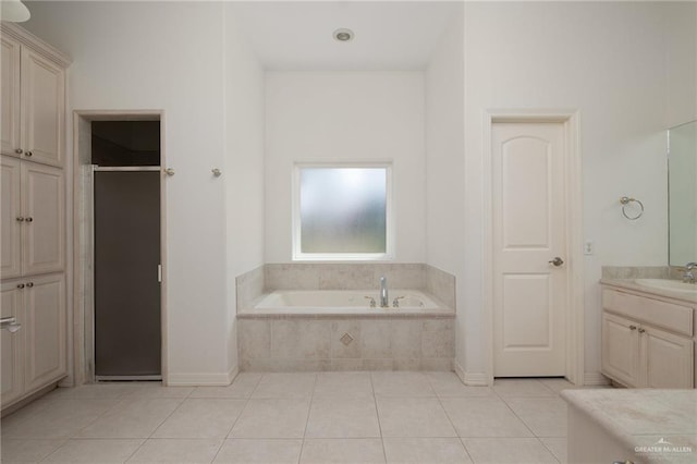 bathroom with a stall shower, a bath, vanity, and tile patterned flooring