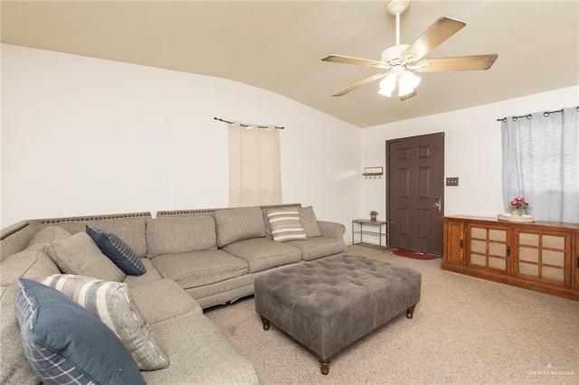 carpeted living room with lofted ceiling and ceiling fan