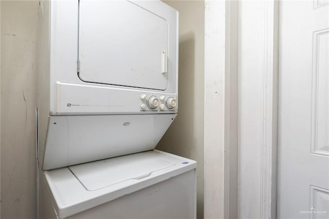 clothes washing area with laundry area and stacked washer / dryer