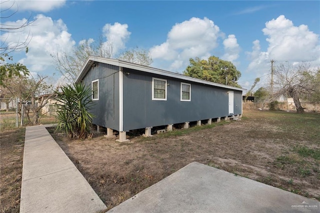 view of side of home featuring fence