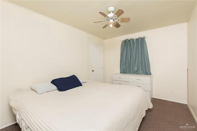 bedroom featuring ceiling fan, dark carpet, and baseboards