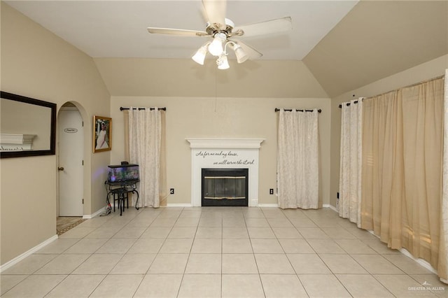 1905 N 8th St, Harlingen, TX 78550 - living area featuring lofted ceiling, ceiling fan, a glass covered fireplace, arched walkways, and light tile patterned floors