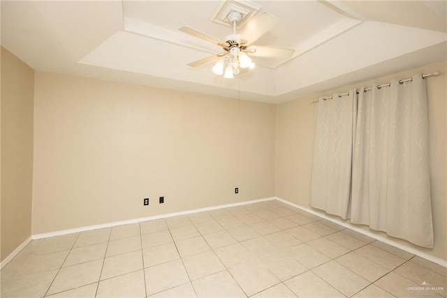 1905 N 8th St, Harlingen, TX 78550 - spare room featuring a raised ceiling, light tile patterned flooring, a ceiling fan, and baseboards