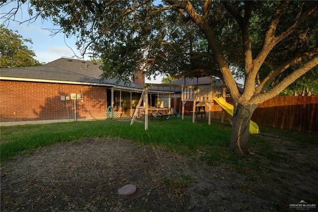 1905 N 8th St, Harlingen, TX 78550 - back of property featuring a playground, brick siding, and a shingled roof