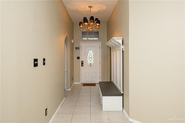1905 N 8th St, Harlingen, TX 78550 - foyer with light tile patterned floors, a chandelier, arched walkways, and baseboards
