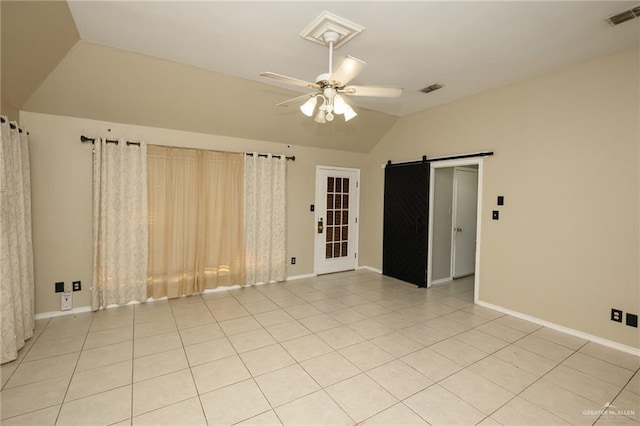 1905 N 8th St, Harlingen, TX 78550 - spare room featuring vaulted ceiling, a barn door, a ceiling fan, baseboards, and light tile patterned flooring