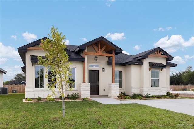 view of front of house featuring central AC and a front lawn