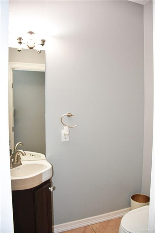 bathroom featuring tile patterned flooring, vanity, and toilet