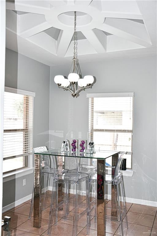 tiled dining room featuring an inviting chandelier and a healthy amount of sunlight