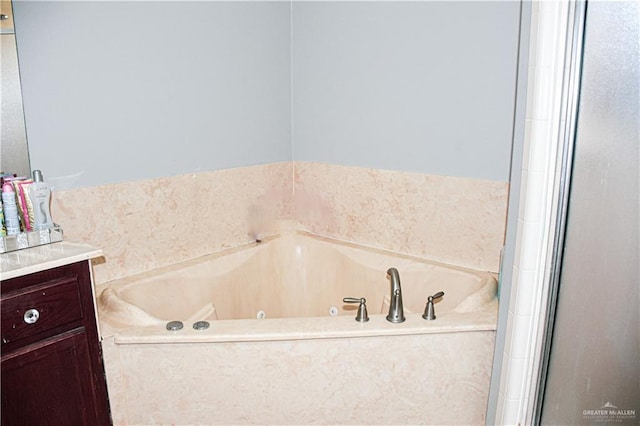 bathroom with vanity and a tub to relax in