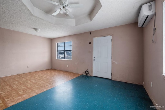 6614 Simon Place Ave, Brownsville, TX 78526 - spare room featuring a wall mounted air conditioner, a ceiling fan, a textured ceiling, and baseboards