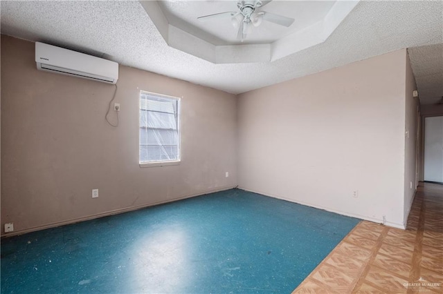 6614 Simon Place Ave, Brownsville, TX 78526 - unfurnished room with a wall mounted air conditioner, ceiling fan, baseboards, and a textured ceiling