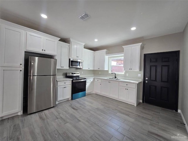 1204 Cornerstone Loop, Rio Grande City, TX 78582 - kitchen with stainless steel appliances, white cabinets, visible vents, and a sink