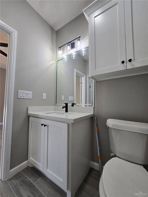 1204 Cornerstone Loop, Rio Grande City, TX 78582 - bathroom with baseboards, vanity, and toilet
