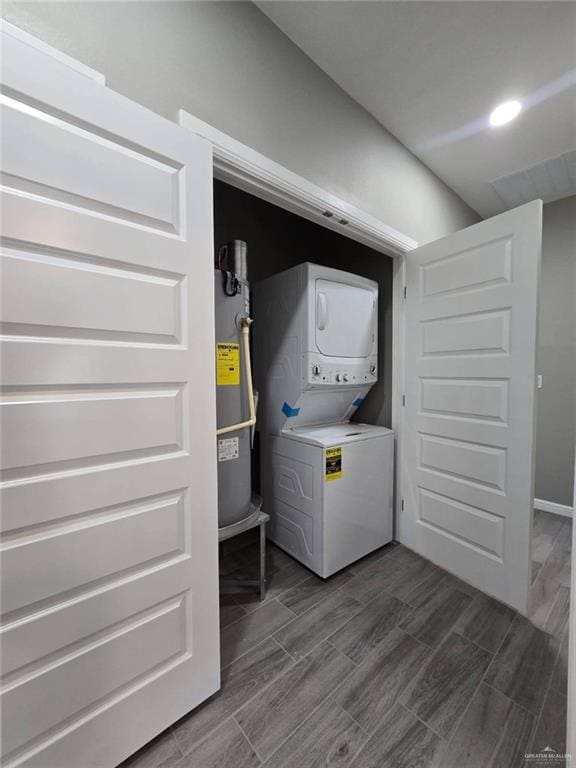 1204 Cornerstone Loop, Rio Grande City, TX 78582 - washroom with stacked washer and dryer, laundry area, wood tiled floor, water heater, and baseboards