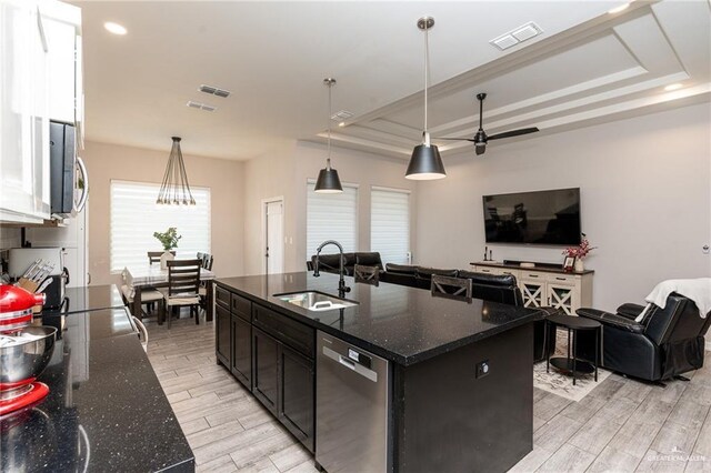 kitchen featuring visible vents, wood finish floors, open floor plan, stainless steel appliances, and a sink