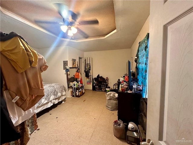 bedroom with a textured ceiling and ceiling fan