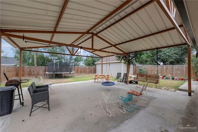 2310 Kim Marie Ave, Mission, TX 78574 - fenced backyard featuring a trampoline, a patio area, and outdoor dining space