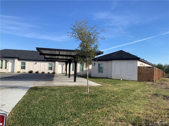 exterior space with a carport and a yard