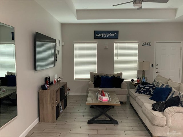 living room featuring ceiling fan and a wealth of natural light