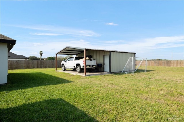 view of outdoor structure with a yard and a carport