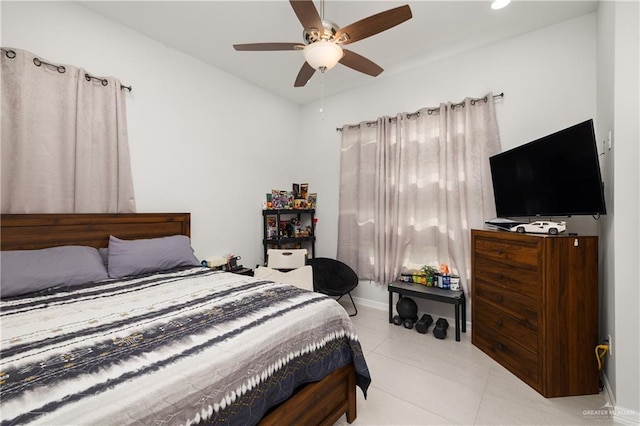 bedroom with ceiling fan and light tile patterned flooring