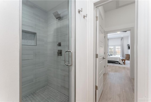 bathroom featuring hardwood / wood-style flooring and a shower with shower door