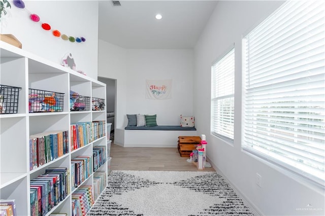 game room with light hardwood / wood-style floors