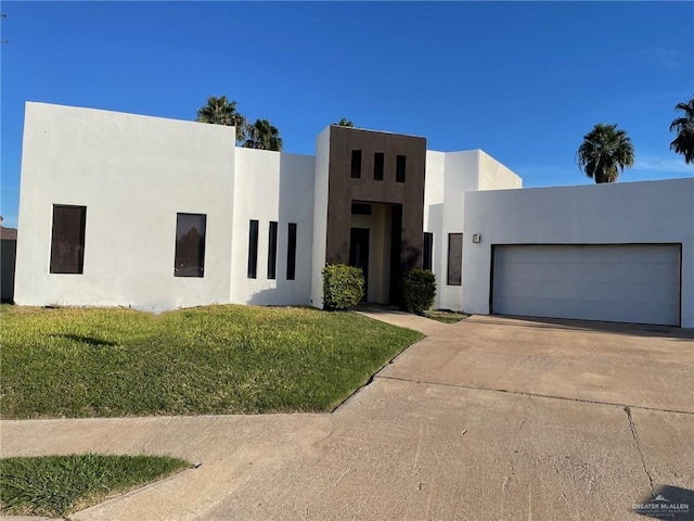 2037 S 45th St, Mcallen, TX 78503 - view of front of property featuring concrete driveway, stucco siding, an attached garage, and a front yard