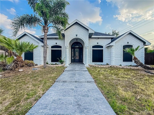 2817 Bluebird Ave, Mcallen, TX 78504 - french country inspired facade with a front yard and brick siding