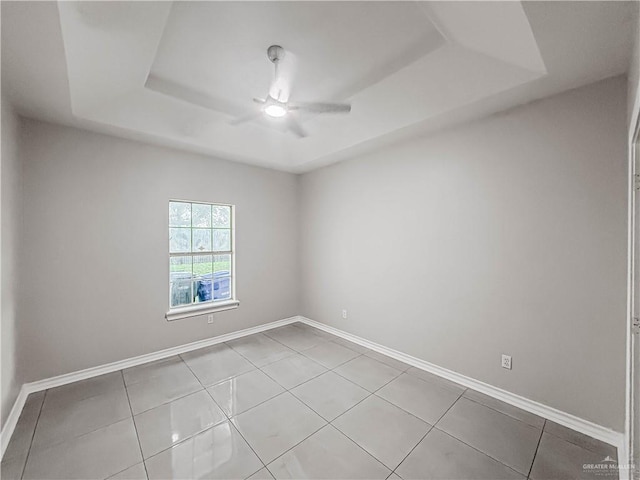 2817 Bluebird Ave, Mcallen, TX 78504 - empty room with a tray ceiling, ceiling fan, baseboards, and light tile patterned floors