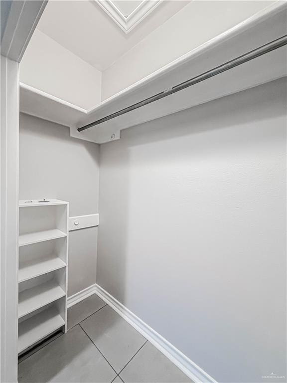 2817 Bluebird Ave, Mcallen, TX 78504 - walk in closet featuring dark tile patterned floors