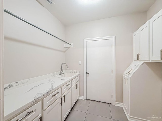 2817 Bluebird Ave, Mcallen, TX 78504 - laundry area with a sink, light tile patterned floors, and baseboards