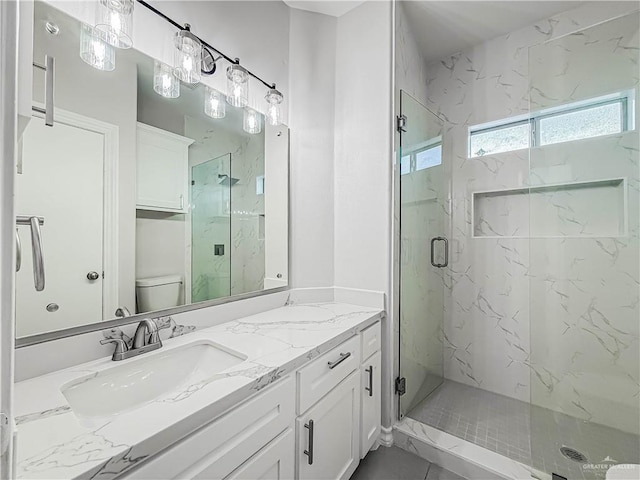2817 Bluebird Ave, Mcallen, TX 78504 - full bath featuring a marble finish shower, double vanity, and toilet