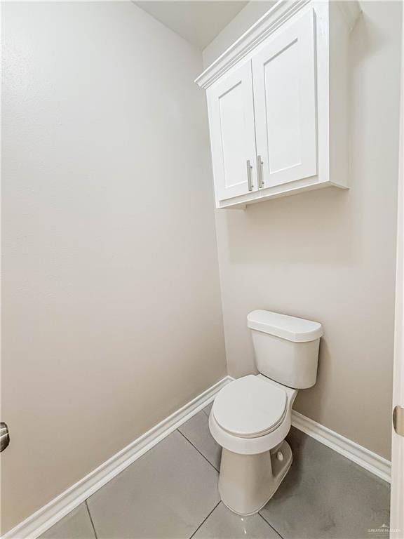 2817 Bluebird Ave, Mcallen, TX 78504 - bathroom featuring baseboards, toilet, and tile patterned flooring