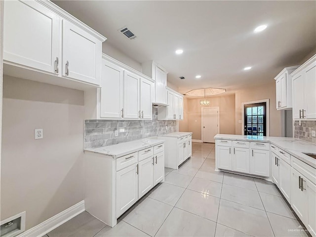 2817 Bluebird Ave, Mcallen, TX 78504 - kitchen with tasteful backsplash, white cabinets, a peninsula, light tile patterned flooring, and recessed lighting