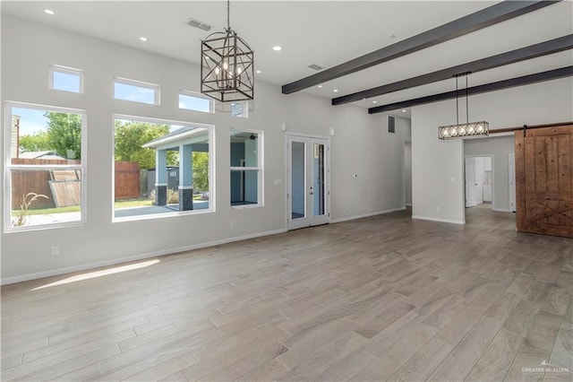 202 Constellation Dr E, Pharr, TX 78577 - unfurnished living room featuring a chandelier, beam ceiling, plenty of natural light, light wood finished floors, and recessed lighting