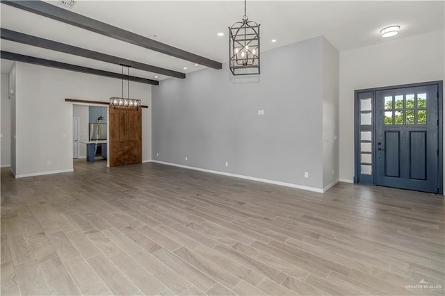 202 Constellation Dr E, Pharr, TX 78577 - entryway featuring a barn door, beamed ceiling, recessed lighting, a chandelier, and light wood-style floors