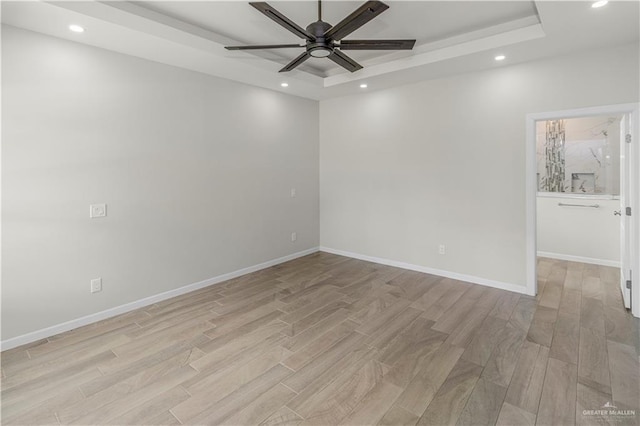 202 Constellation Dr E, Pharr, TX 78577 - spare room with a raised ceiling, a ceiling fan, light wood-style flooring, and recessed lighting