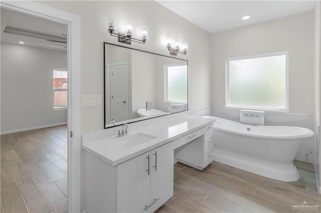 202 Constellation Dr E, Pharr, TX 78577 - full bathroom featuring vanity, a freestanding tub, healthy amount of natural light, wood finished floors, and recessed lighting