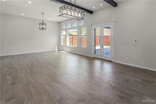 202 Constellation Dr E, Pharr, TX 78577 - spare room with a chandelier, recessed lighting, dark wood-style flooring, french doors, and beamed ceiling