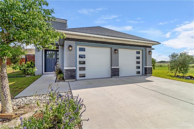 202 Constellation Dr E, Pharr, TX 78577 - prairie-style home with stone siding, concrete driveway, an attached garage, a front yard, and stucco siding