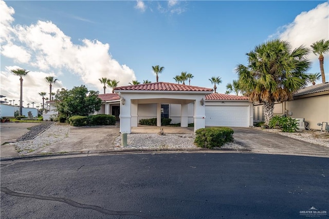 mediterranean / spanish house with a garage