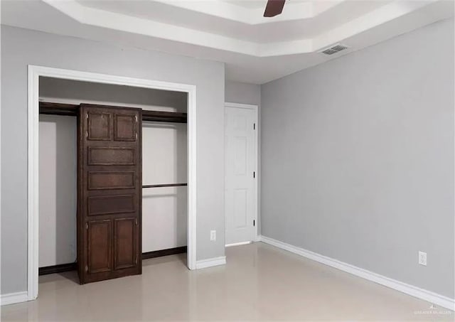 unfurnished bedroom with visible vents, ceiling fan, baseboards, a closet, and a raised ceiling