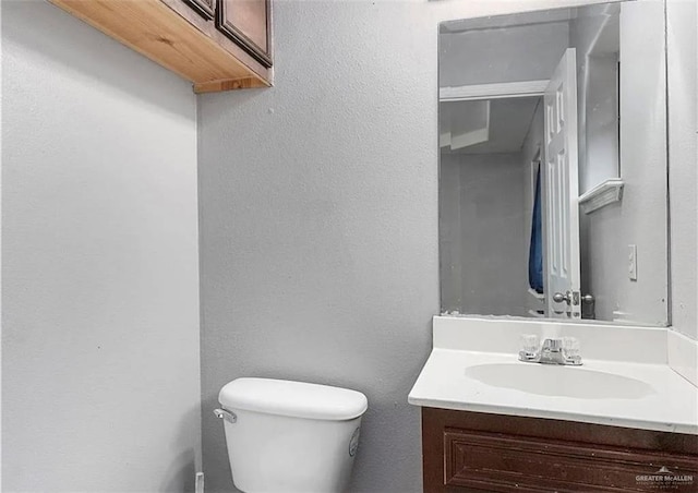 half bathroom featuring toilet and vanity