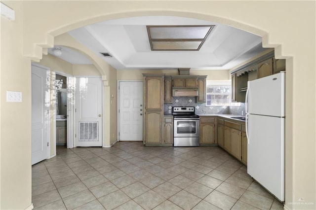 kitchen with backsplash, white refrigerator, a raised ceiling, electric range, and light tile patterned flooring