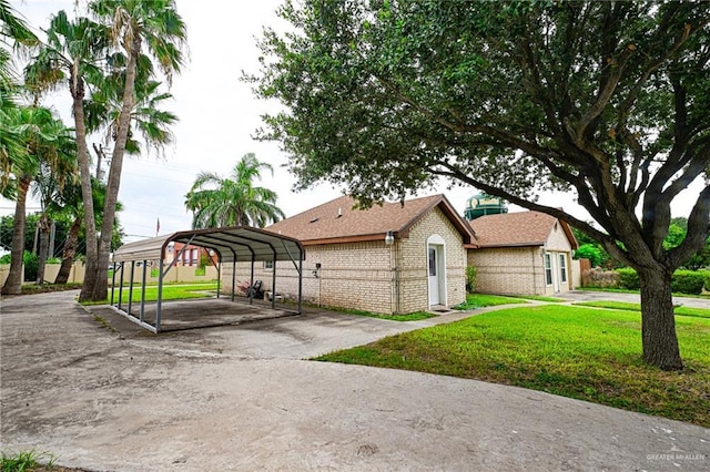 exterior space featuring a lawn and a carport