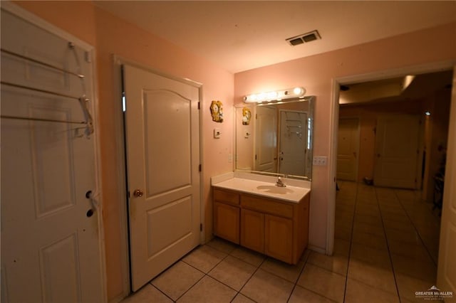 bathroom featuring tile patterned flooring and vanity